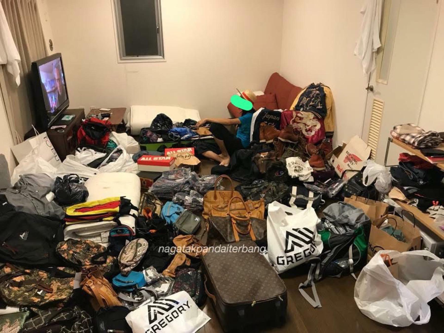 Living room floor covered with Gregory bags, LV luggage, Red Wing boots, Converse boxes and sukajan jackets