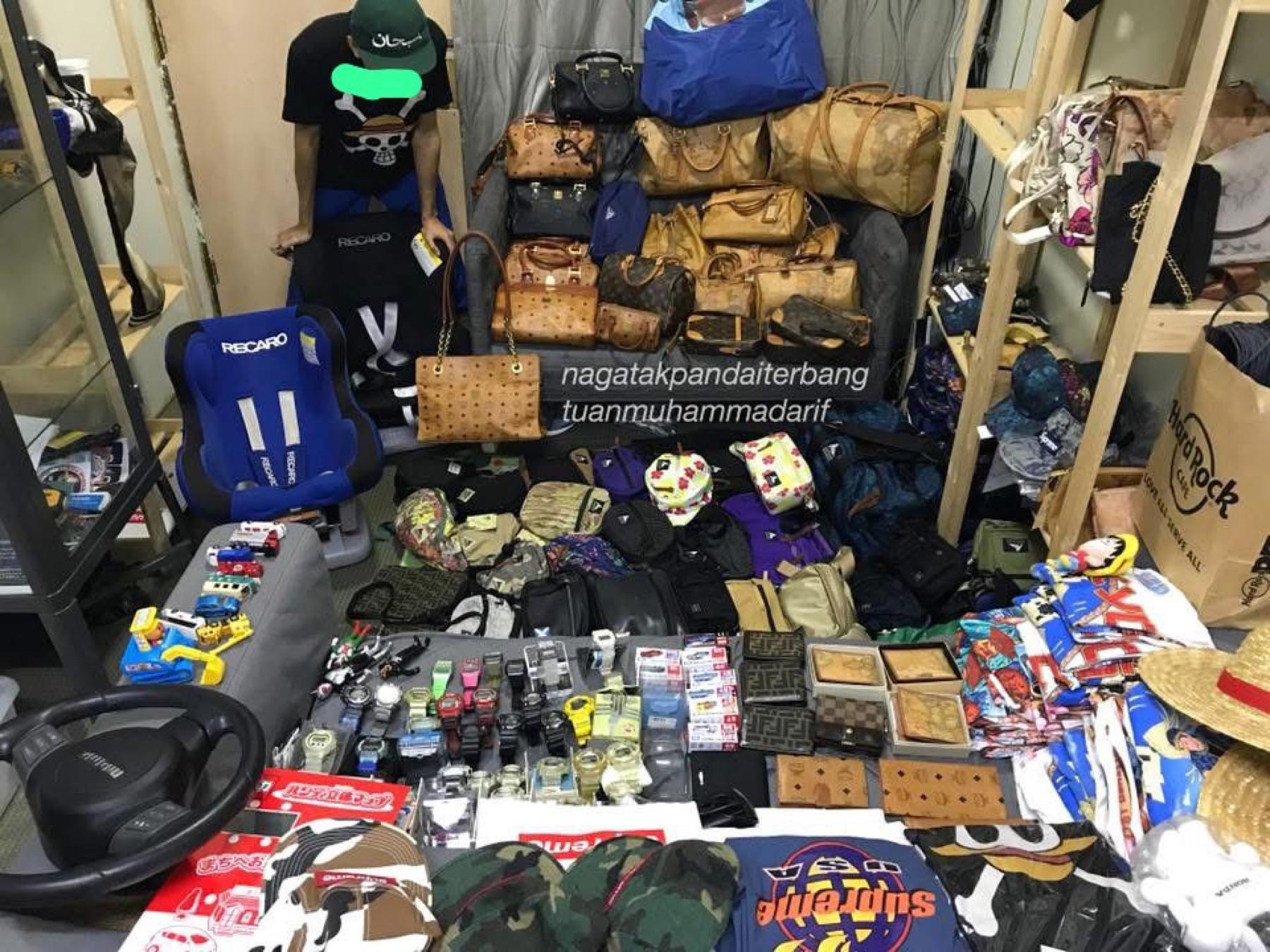 Small shop with a wall of MCM bags, Recaro seats, G-Shock watches, Supreme caps and toy cars