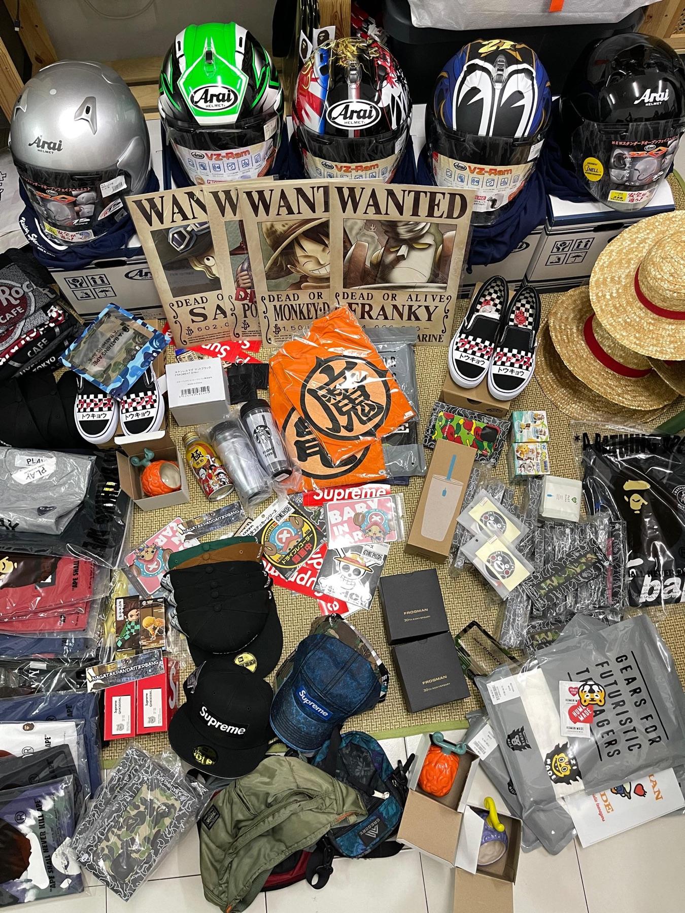 Five Arai helmets, One Piece wanted posters, Luffy straw hats, Vans, Supreme caps, Frogman watch boxes, Dragon Ball tee and Kumamon goods