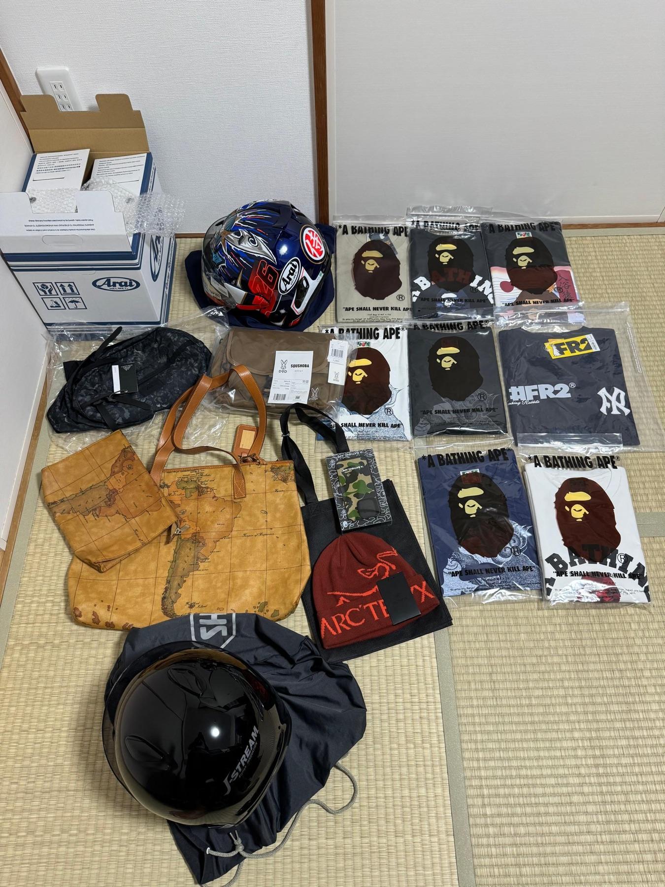 Blue graphic Arai helmet, Alviero Martini map tote, Arc'teryx beanie, DOD bag, FR2 tee and eight BAPE tees, black Shoei J-Stream