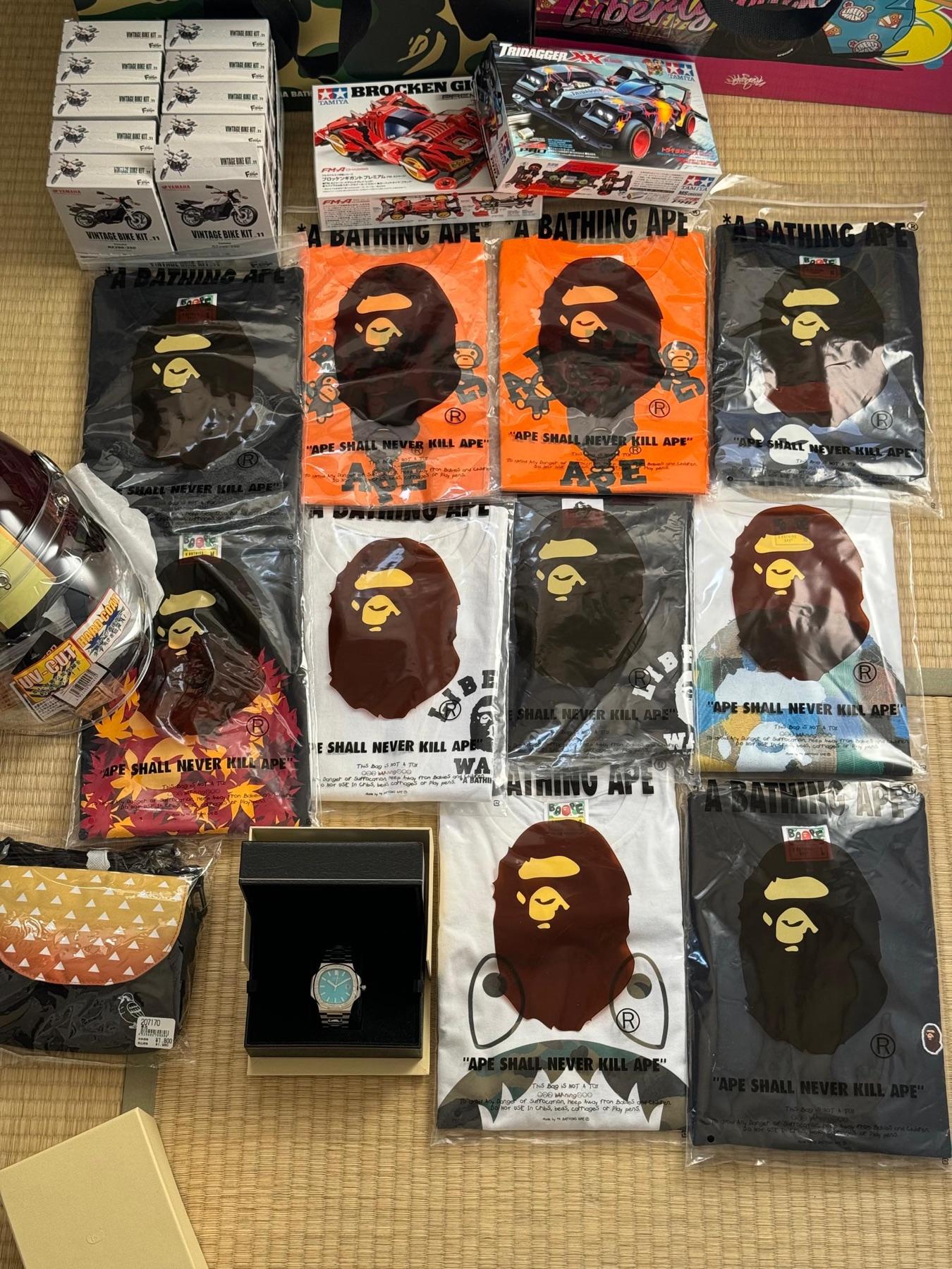 Eleven BAPE tees, Tamiya Mini 4WD kits, Yamaha vintage bike model kits, a blue dial steel watch and a helmet visor