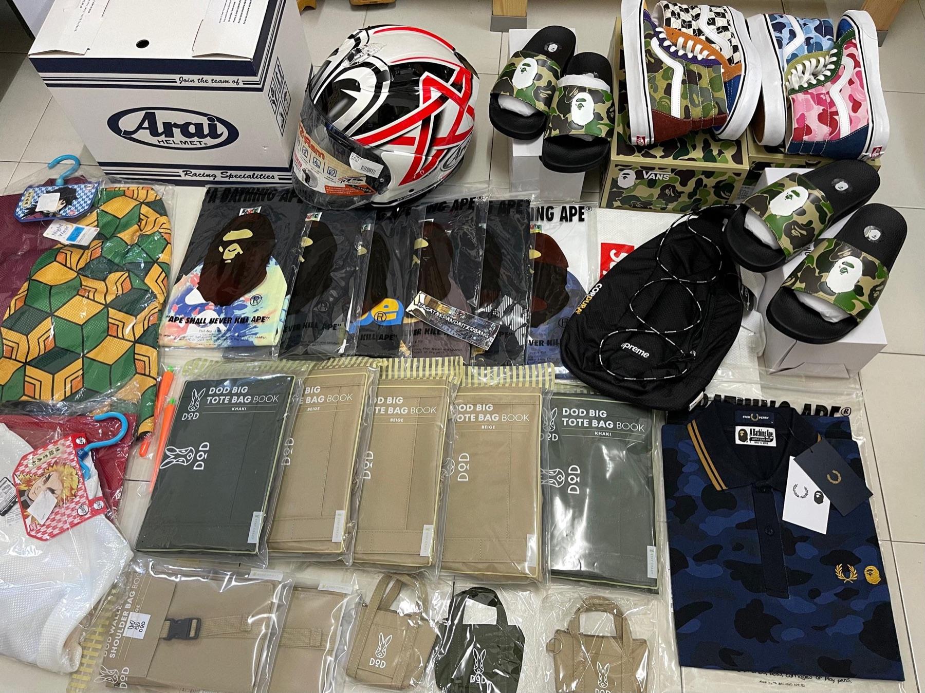 Red and white Arai helmet, BAPE camo slides, BAPE x Vans Sk8-Hi, DOD tote bag books, Fred Perry x BAPE polo and Demon Slayer items