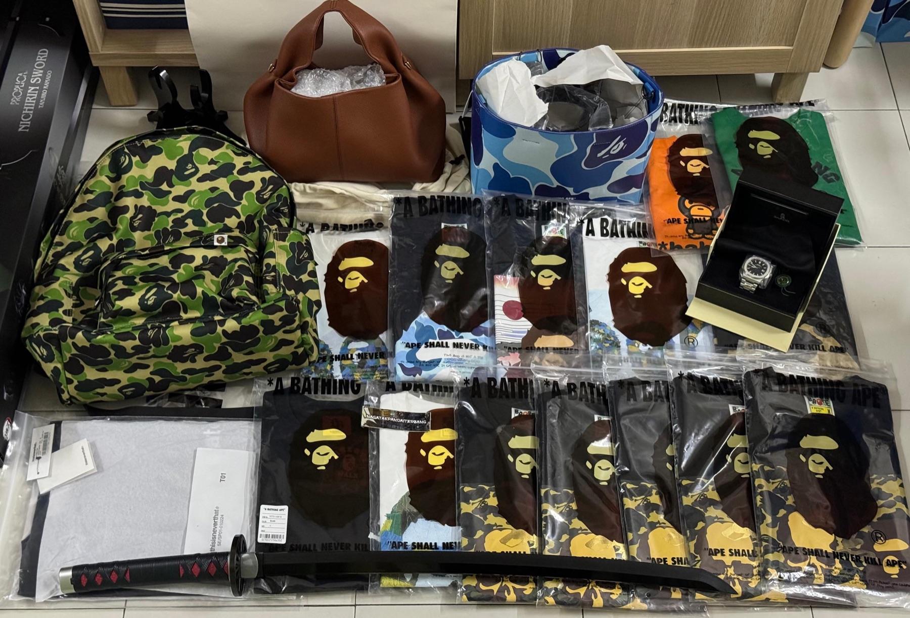 BAPE camo backpack, Polene tan leather bag, blue camo bucket bag, watch in box, Proplica Nichirin sword and many BAPE tees